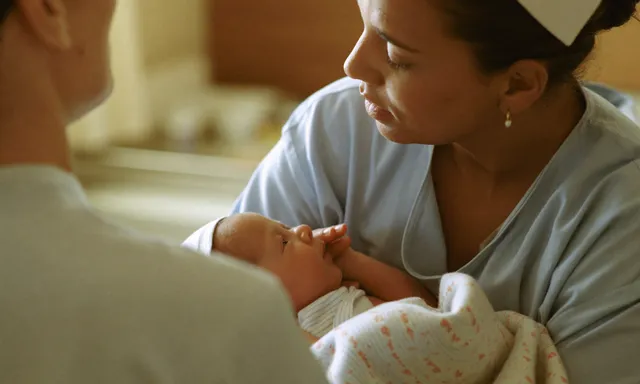 A nurse cradles a newborn in the Geeta Sandhu Women's Health unit